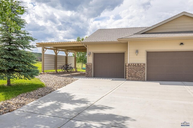 ranch-style home with a garage and a carport