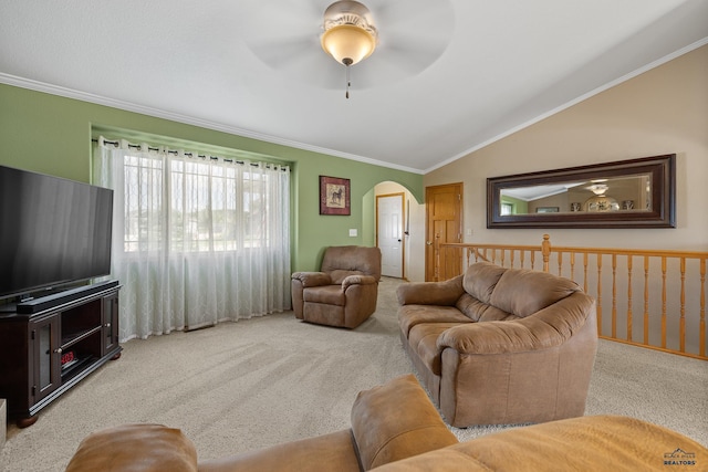 living room with ceiling fan, ornamental molding, light carpet, and vaulted ceiling