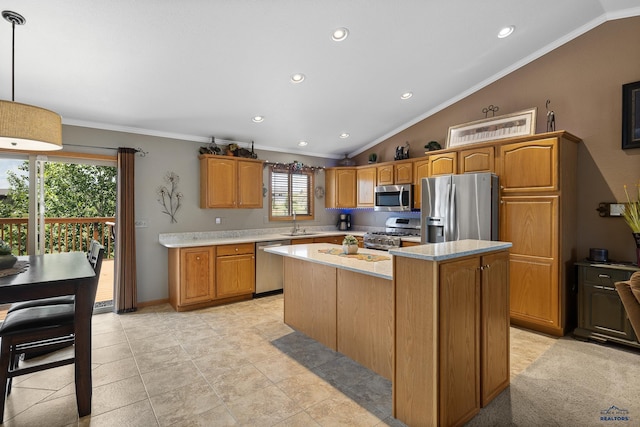 kitchen featuring crown molding, appliances with stainless steel finishes, lofted ceiling, pendant lighting, and a kitchen island