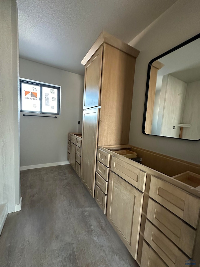 bathroom featuring a textured ceiling and vanity