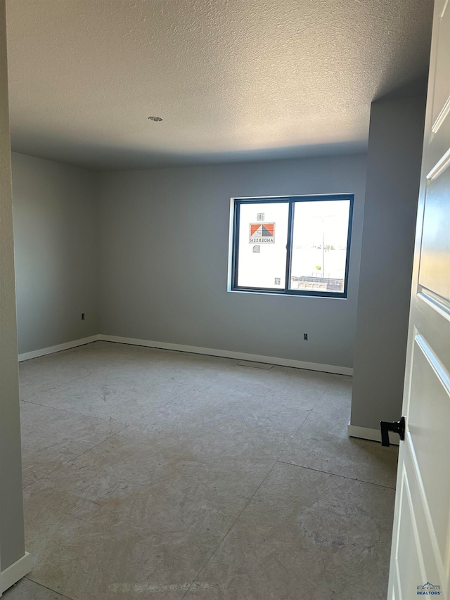 spare room featuring a textured ceiling