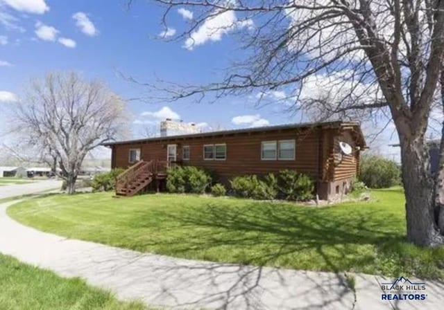 log-style house with a front lawn