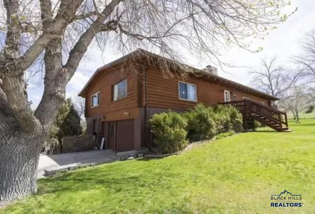 view of home's exterior with a yard and a garage