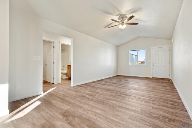 interior space featuring ceiling fan, light hardwood / wood-style floors, and vaulted ceiling