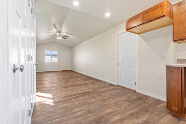 bonus room featuring dark wood-type flooring, ceiling fan, and lofted ceiling