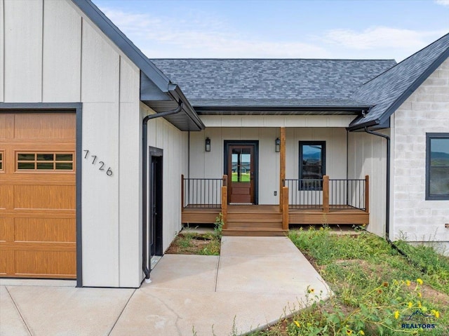 doorway to property featuring a garage and a porch