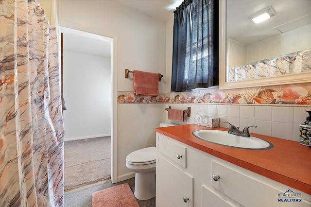 bathroom featuring decorative backsplash, vanity, and toilet