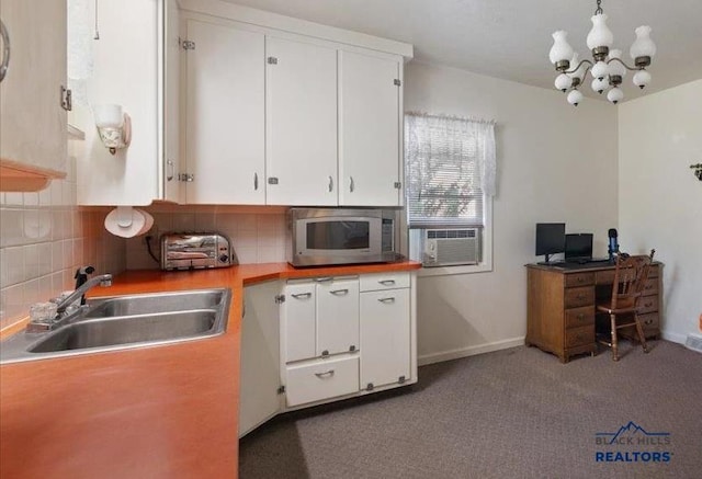 914 Kingsbury St, Belle Fourche, SD 57717 - kitchen with a sink, stainless steel microwave, cooling unit, and white cabinets