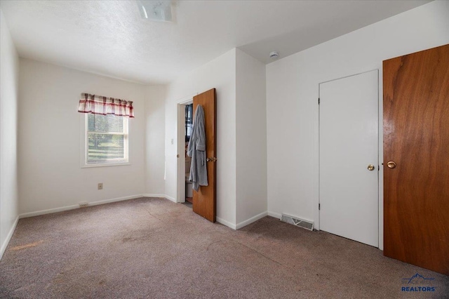 unfurnished bedroom with light colored carpet