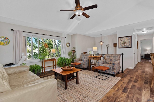 living room featuring hardwood / wood-style floors, vaulted ceiling, and ceiling fan