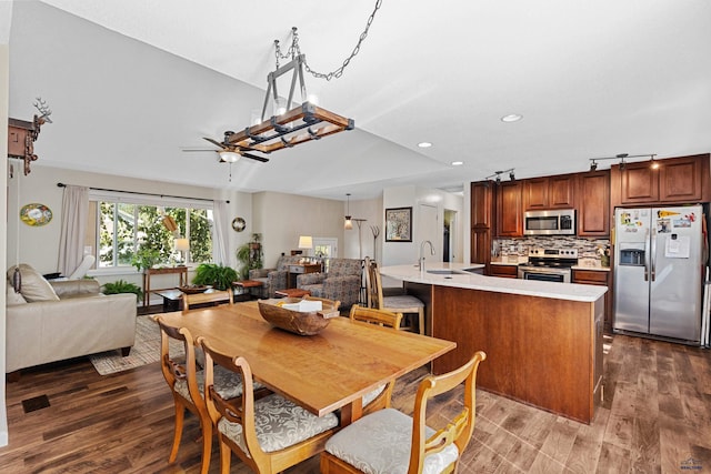 dining room featuring dark wood-type flooring, ceiling fan, and sink