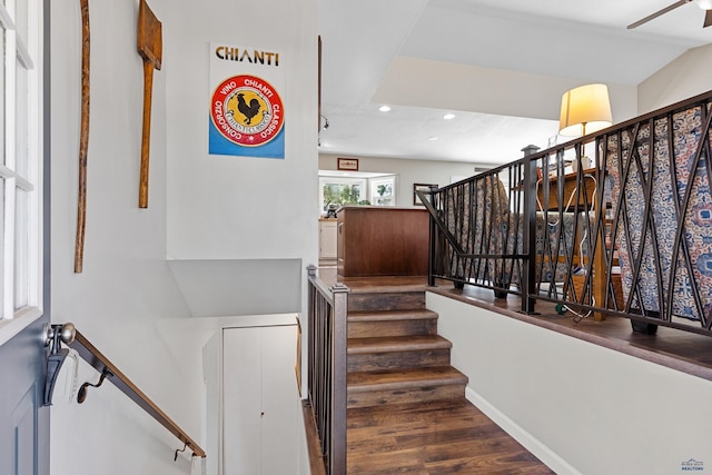 staircase featuring hardwood / wood-style floors and vaulted ceiling