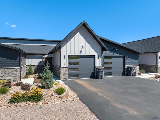 modern inspired farmhouse with a garage