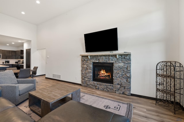 living room with a fireplace and light hardwood / wood-style flooring