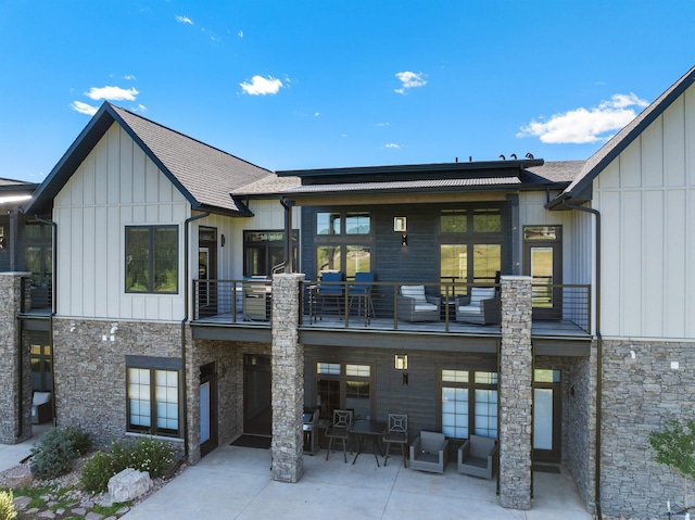 back of house with a balcony and a patio area