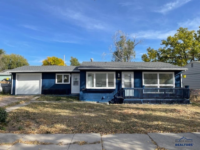 1022 Blaine Ave, Rapid City, SD 57701 - ranch-style house featuring concrete block siding, driveway, roof with shingles, an attached garage, and covered porch