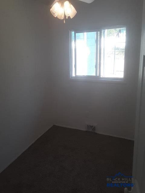 unfurnished room with a healthy amount of sunlight and ceiling fan