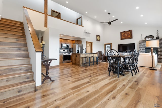 23974 Thompson Dr, Hill City, SD 57745 - dining space with stairs, light wood-type flooring, recessed lighting, high vaulted ceiling, and a ceiling fan