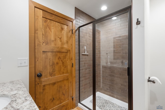 23974 Thompson Dr, Hill City, SD 57745 - full bathroom with a stall shower, vanity, and recessed lighting
