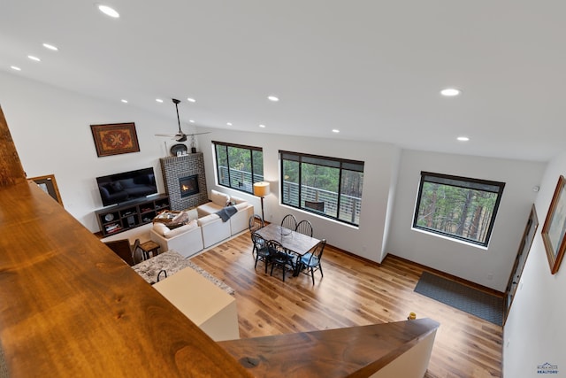 23974 Thompson Dr, Hill City, SD 57745 - living room featuring a glass covered fireplace, light wood-style floors, and recessed lighting