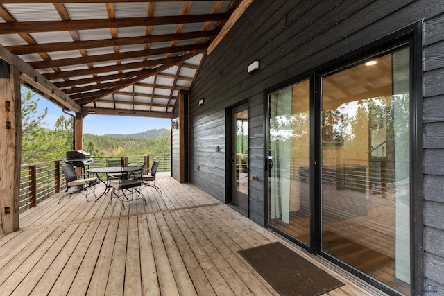 23974 Thompson Dr, Hill City, SD 57745 - wooden deck with outdoor dining space, a mountain view, and a grill