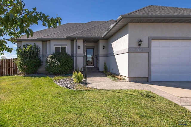 ranch-style home featuring a garage and a front yard