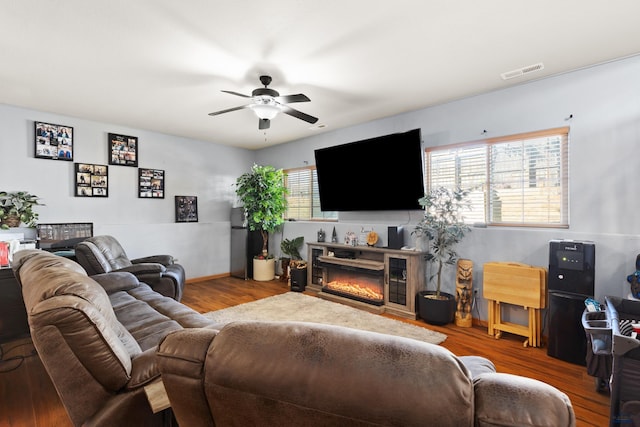 living room featuring ceiling fan and hardwood / wood-style floors