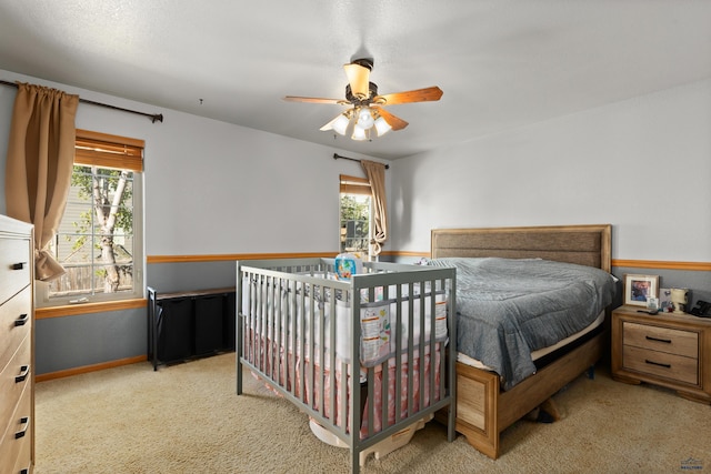 carpeted bedroom featuring ceiling fan