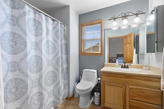 bathroom featuring a shower with curtain, vanity, tile patterned flooring, and toilet