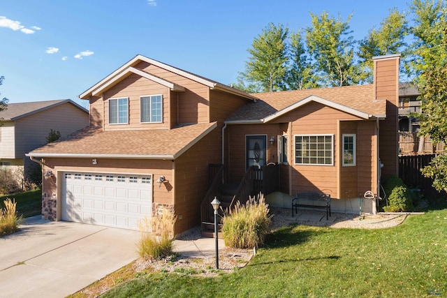 view of front of house with a garage and a front yard