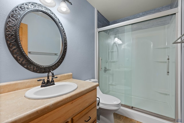 bathroom with vanity, toilet, tile patterned floors, and an enclosed shower