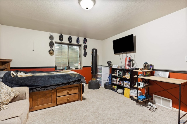 carpeted bedroom featuring a textured ceiling