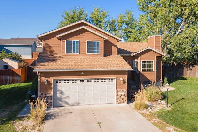 view of front of property featuring a garage and a front yard