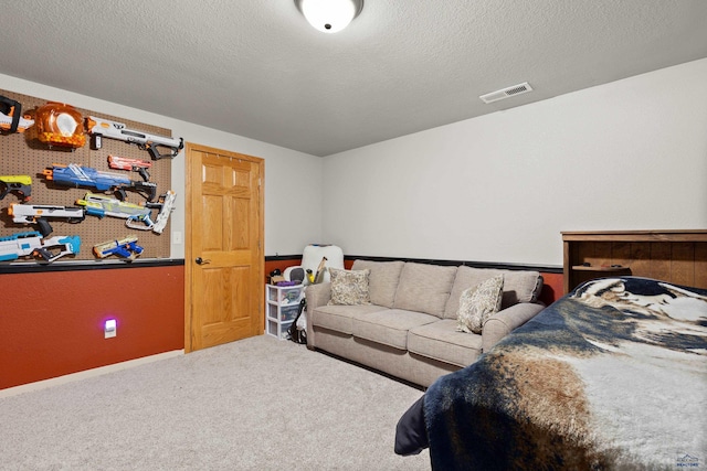 bedroom with carpet floors and a textured ceiling