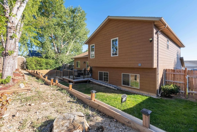 view of side of property with a lawn and a deck