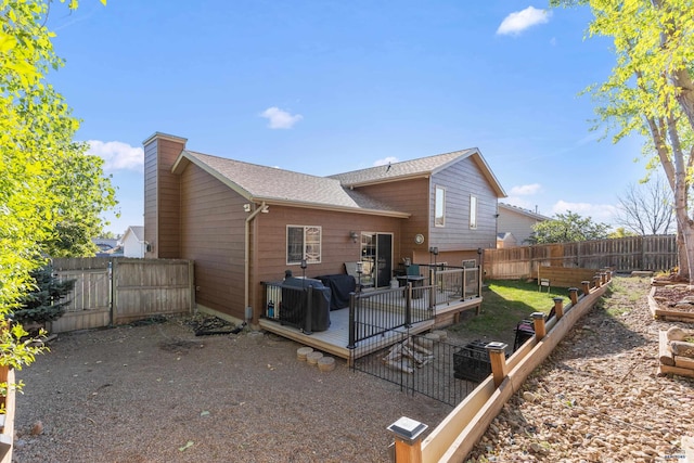 rear view of house featuring a wooden deck