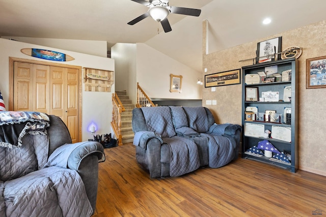 living room featuring vaulted ceiling, ceiling fan, and hardwood / wood-style flooring