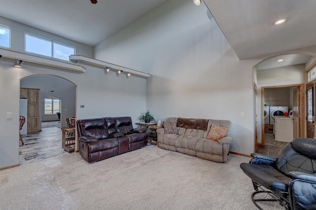 11845 N Haines Ave, Rapid City, SD 57701 - living room with washer and dryer, arched walkways, a towering ceiling, and plenty of natural light