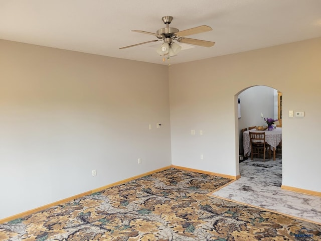11845 N Haines Ave, Rapid City, SD 57701 - unfurnished room with arched walkways, baseboards, and a ceiling fan
