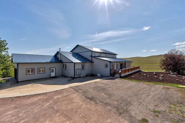 11845 N Haines Ave, Rapid City, SD 57701 - back of property featuring a patio area, a wooden deck, and metal roof
