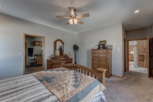11845 N Haines Ave, Rapid City, SD 57701 - bedroom with baseboards, connected bathroom, ceiling fan, and light carpet
