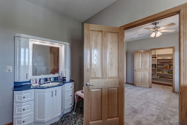 11845 N Haines Ave, Rapid City, SD 57701 - bathroom with vanity, baseboards, a ceiling fan, and lofted ceiling