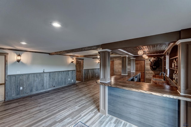 11845 N Haines Ave, Rapid City, SD 57701 - bar featuring beamed ceiling, ornate columns, wood finished floors, a sink, and wainscoting