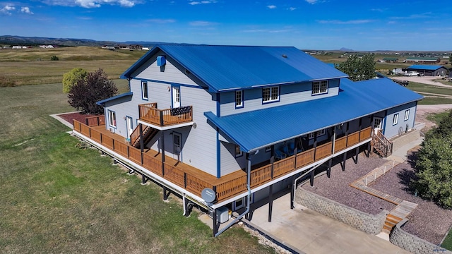 11845 N Haines Ave, Rapid City, SD 57701 - exterior space featuring a deck, a yard, metal roof, stairway, and concrete driveway
