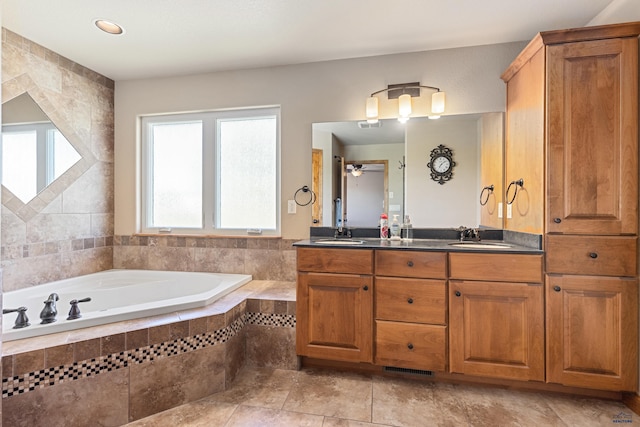 bathroom featuring vanity and tiled bath