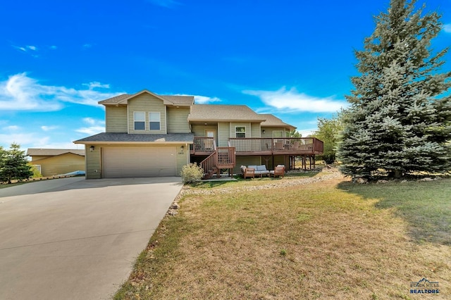 view of front facade with a garage, a wooden deck, and a front yard