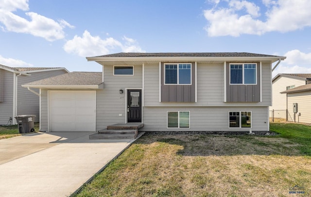 view of front of house with a front yard and a garage