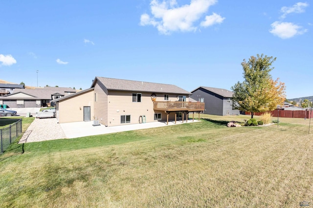 rear view of house with a lawn and a patio