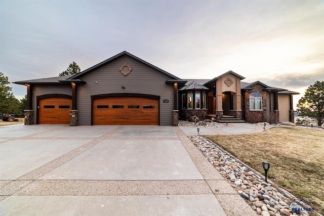 view of front of home with a garage and a yard