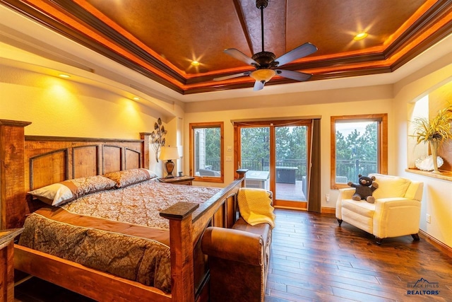 bedroom with dark wood-type flooring, crown molding, access to exterior, and a raised ceiling